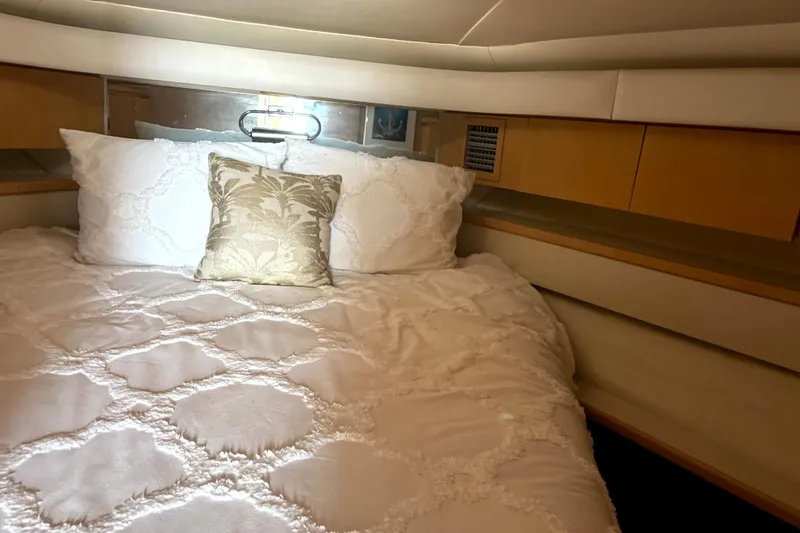 Slide: The Image of Luxurious cabin interior of 1993 Tiara Yachts 43 Open with elegant bedding. - 22