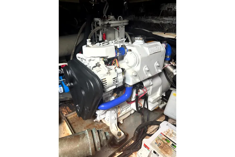 Slide: The Image of Engine of a 1993 Tiara Yachts 43 Open, featuring blue hoses and detailed components. - 23