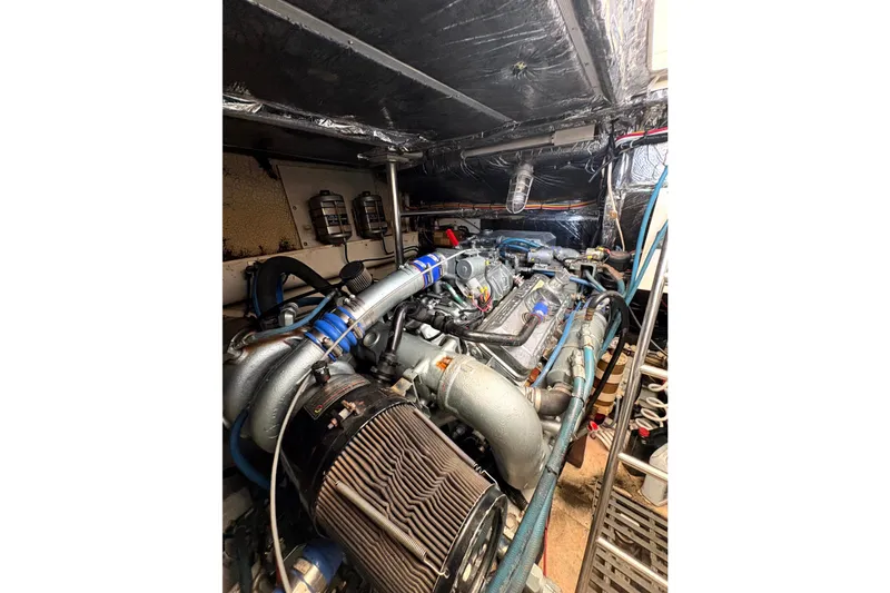 Slide: The Image of Engine room of 1993 Tiara Yachts 43 Open, showcasing complex machinery and components. - 26