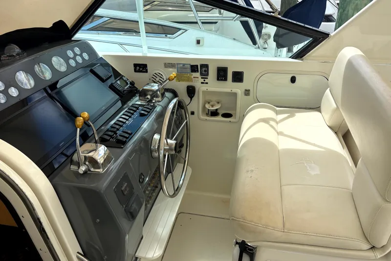 Slide: The Image of 1993 Tiara Yachts 43 Open helm with steering wheel and control panel. - 5