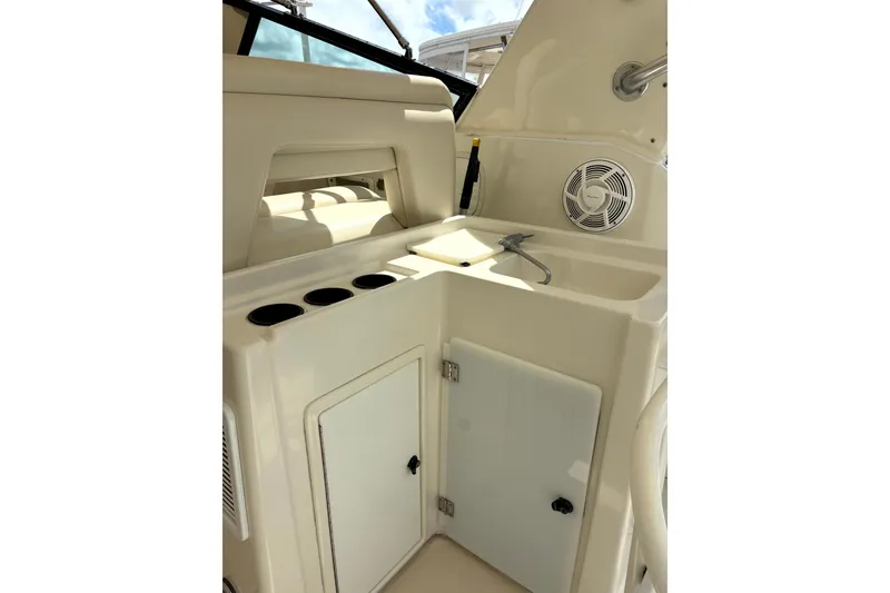 Slide: The Image of 1993 Tiara Yachts 43 Open interior with sink, storage, and cup holders. - 7
