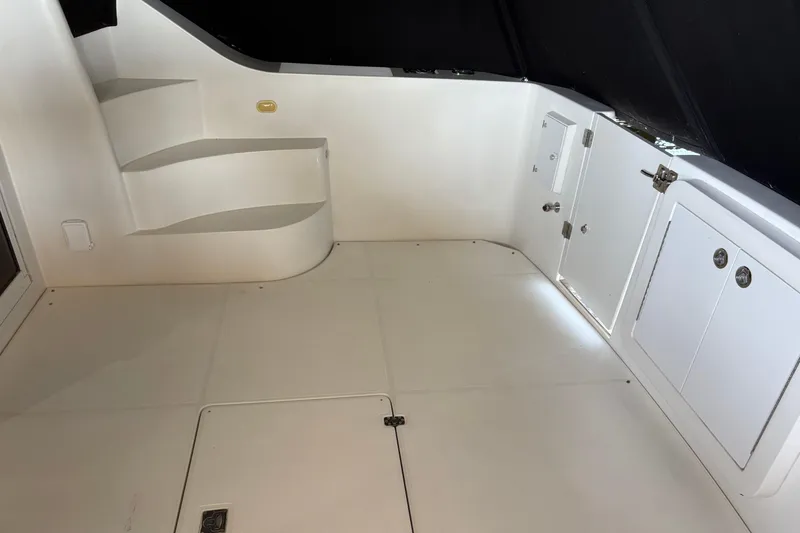 Slide: The Image of Interior of a 2007 Carver 42 Super Sport yacht, featuring white steps and storage compartments. - 14