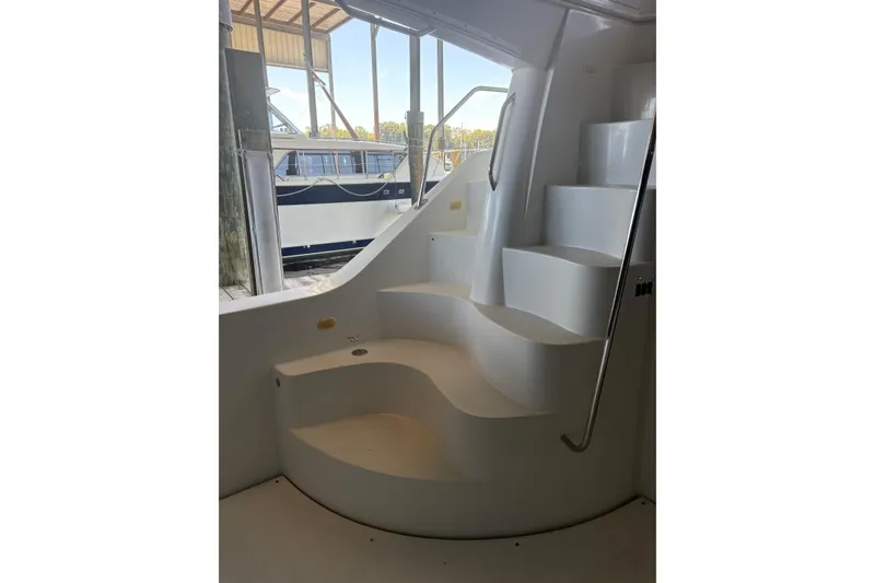 Slide: The Image of Staircase on 2007 Carver 42 Super Sport yacht, docked with another boat visible outside. - 15