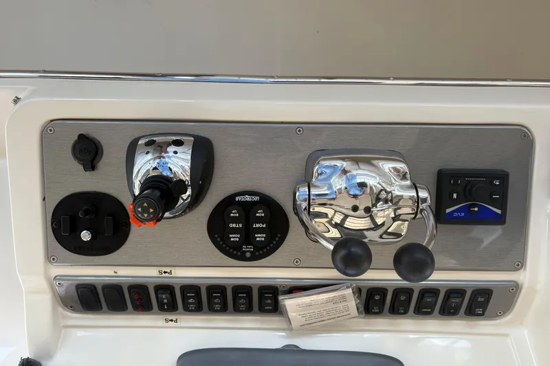 Slide: The Image of Control panel of a 2007 Carver 42 Super Sport boat with various switches and levers. - 16