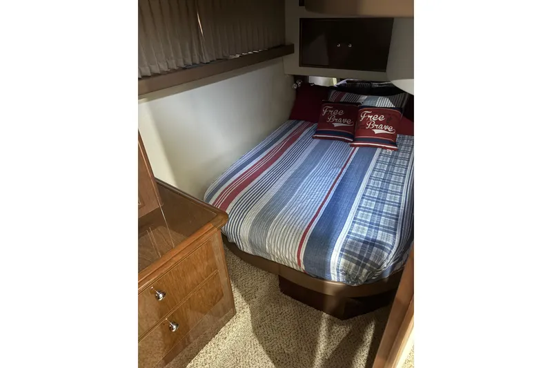 Slide: The Image of 2007 Carver 42 Super Sport bedroom with striped bedding and "Free Brave" pillows. - 9