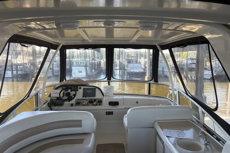 Slide: The Image of Interior view of 2007 Carver 42 Super Sport yacht helm with marina background. - 17