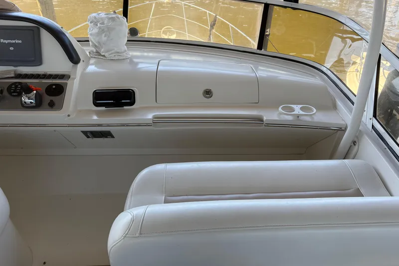 Slide: The Image of Interior of 2007 Carver 42 Super Sport yacht with white seating and dashboard. - 20