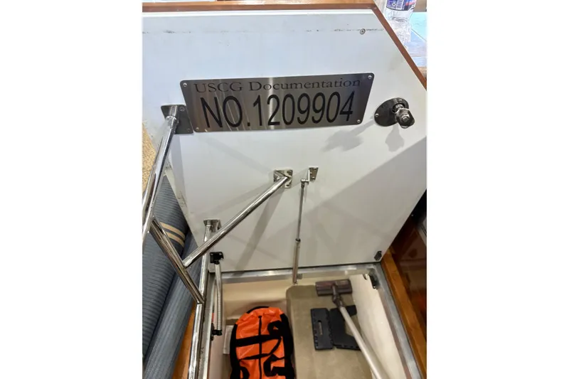 Slide: The Image of USCG documentation plaque on 2007 Carver 42 Super Sport boat with storage compartment. - 22