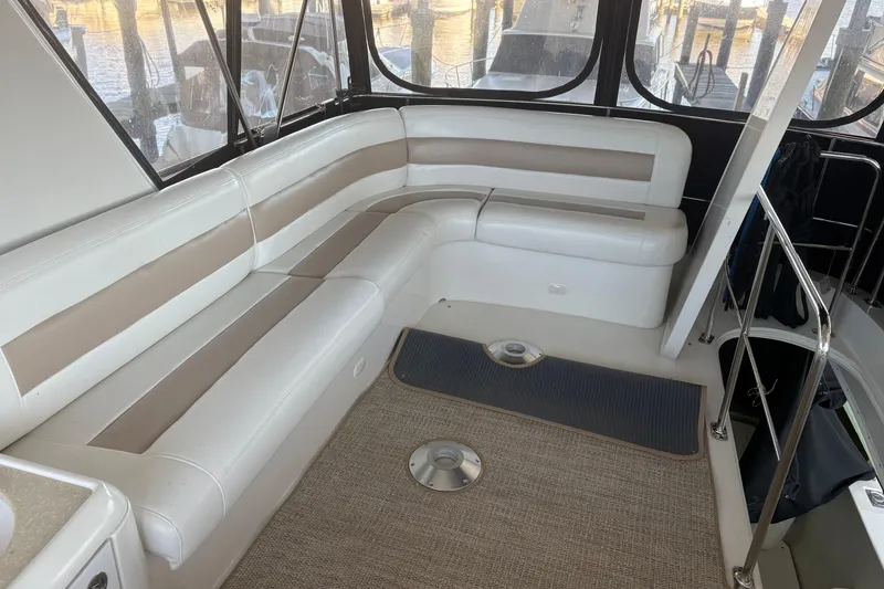 Slide: The Image of 2007 Carver 42 Super Sport yacht interior with beige and white seating. - 23