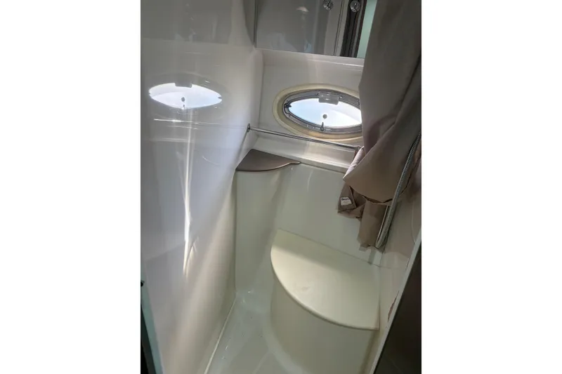 Slide: The Image of 2007 Carver 42 Super Sport yacht bathroom with porthole and curtain. - 4