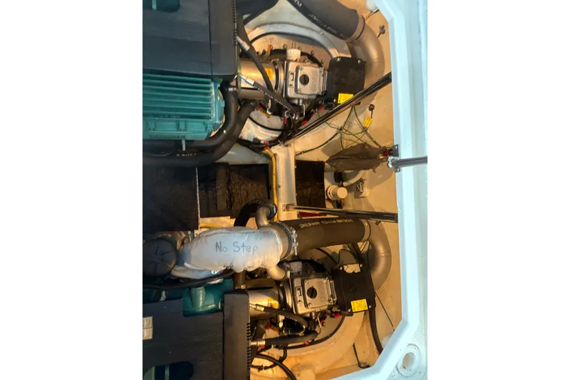 Slide: The Image of Engine room of 2007 Carver 42 Super Sport yacht, showing mechanical components and "No Step" label. - 5