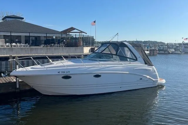 The Image of 2005 Chaparral 290 Signature boat docked at marina with American flag. - 0