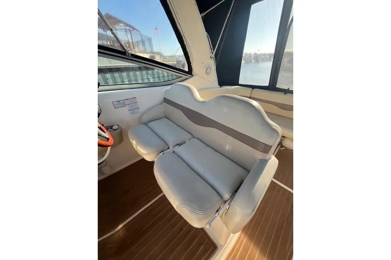Slide: The Image of 2005 Chaparral 290 Signature boat interior with cushioned seating and wooden flooring. - 11