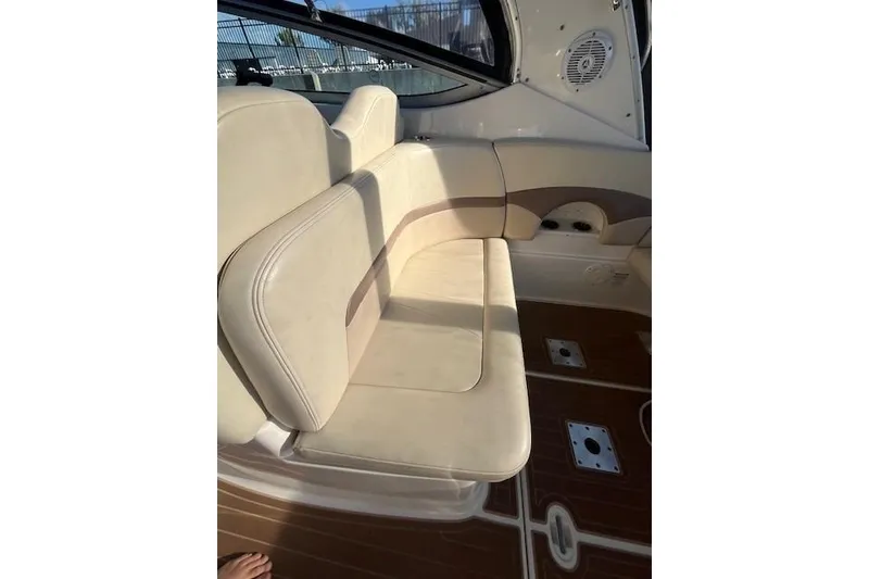 Slide: The Image of 2005 Chaparral 290 Signature boat interior with beige seating and wood flooring. - 12