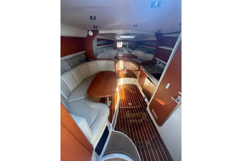 Slide: The Image of 2005 Chaparral 290 Signature cabin interior with wood flooring and cozy seating area. - 16