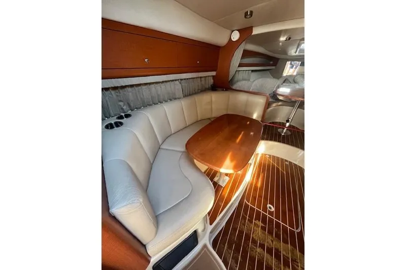 Slide: The Image of Luxurious interior of 2005 Chaparral 290 Signature boat with elegant seating and wooden table. - 17