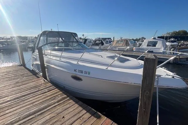 Slide: The Image of 2005 Chaparral 290 Signature boat docked at a marina under clear blue skies. - 2