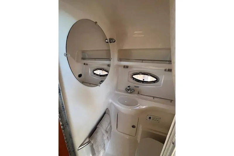 Slide: The Image of Bathroom interior of 2005 Chaparral 290 Signature boat with mirror and porthole window. - 24