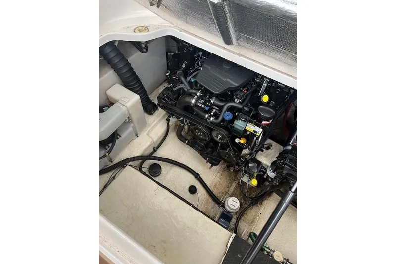Slide: The Image of Engine compartment of a 2005 Chaparral 290 Signature boat, showcasing mechanical components. - 26
