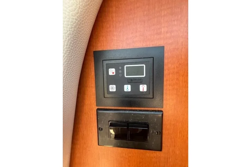 Slide: The Image of Control panel on 2005 Chaparral 290 Signature boat interior, featuring digital display and switches. - 29