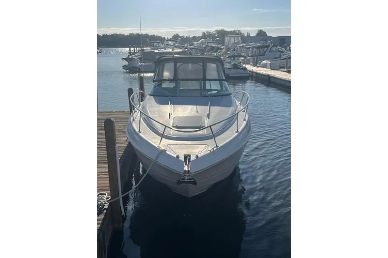 Slide: The Image of 2005 Chaparral 290 Signature boat docked in a marina under clear skies. - 3