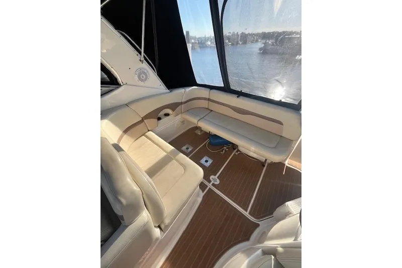 Slide: The Image of 2005 Chaparral 290 Signature boat interior with beige seating and wood flooring. - 6