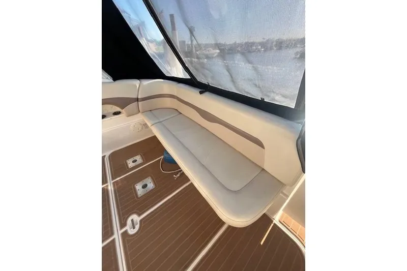 Slide: The Image of 2005 Chaparral 290 Signature boat interior with cushioned seating and wooden flooring. - 7
