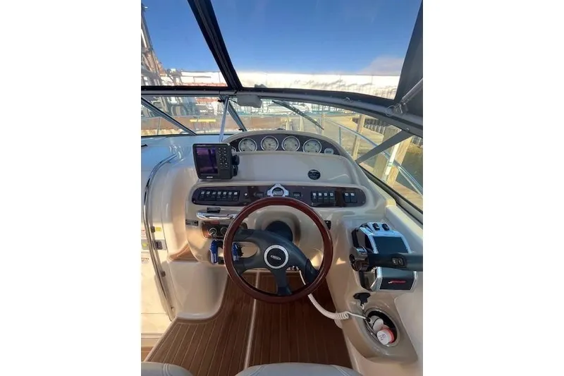 Slide: The Image of 2005 Chaparral 290 Signature boat dashboard with steering wheel and navigation instruments. - 8