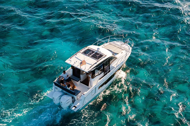 Slide: The Image of 2026 Jeanneau NC 895 Series 2 cruising on clear turquoise waters. - 8