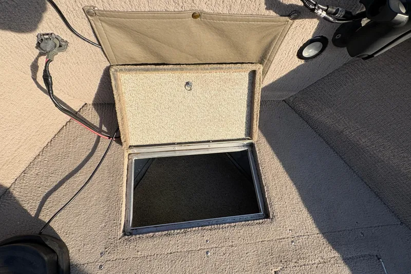 Slide: The Image of Open storage compartment on 2004 Lund 1800 Explorer SS boat interior. - 11