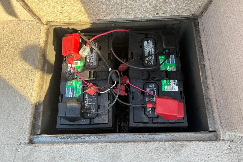 Slide: The Image of Four marine batteries in a 2004 Lund 1800 Explorer SS boat compartment. - 14