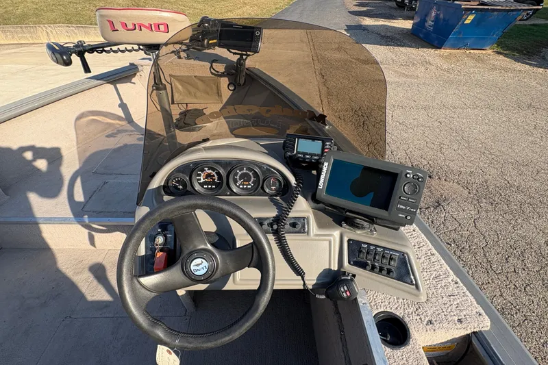 Slide: The Image of 2004 Lund 1800 Explorer SS boat dashboard with steering wheel and navigation equipment. - 16