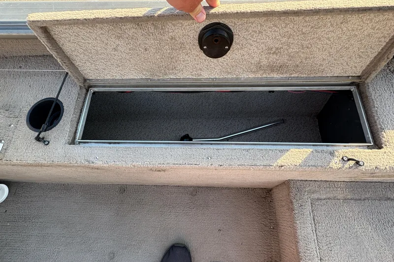Slide: The Image of Open storage compartment in 2004 Lund 1800 Explorer SS boat interior. - 18