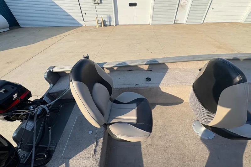 Slide: The Image of 2004 Lund 1800 Explorer SS boat interior with two seats and motor. - 22