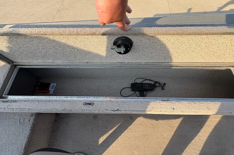 Slide: The Image of Open storage compartment in 2004 Lund 1800 Explorer SS boat with accessories inside. - 23