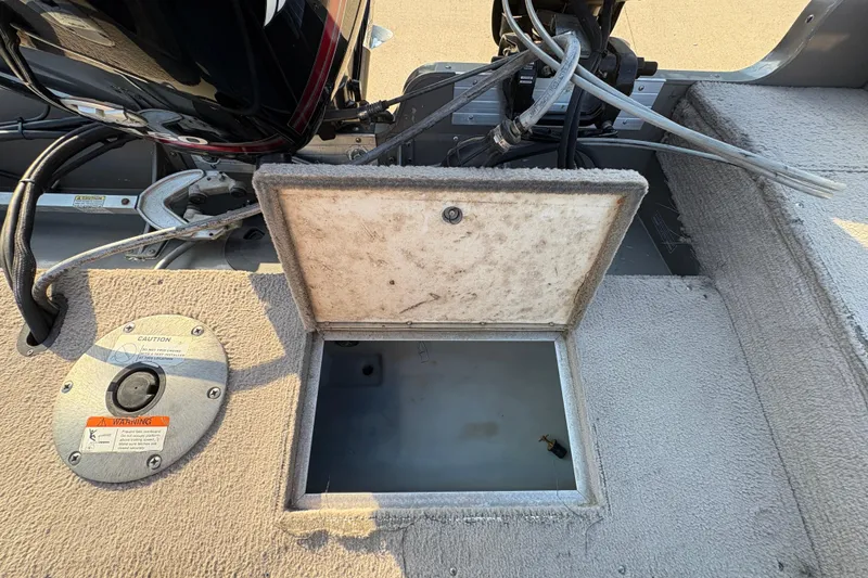 Slide: The Image of Open storage compartment on a 2004 Lund 1800 Explorer SS boat deck. - 26