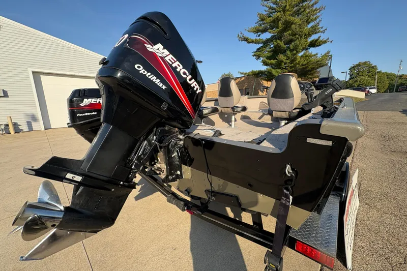 Slide: The Image of 2004 Lund 1800 Explorer SS boat with Mercury OptiMax engine, parked outdoors. - 30