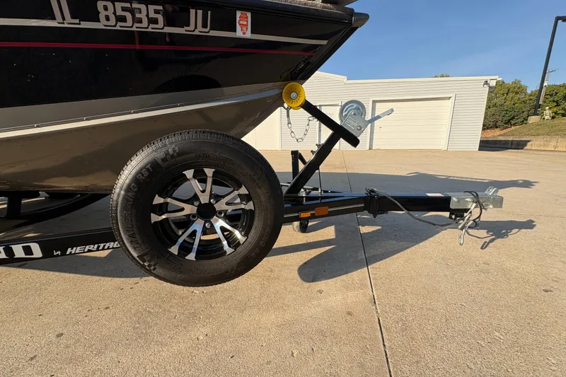 Slide: The Image of Trailer of 2004 Lund 1800 Explorer SS boat with black wheel and hitch. - 31