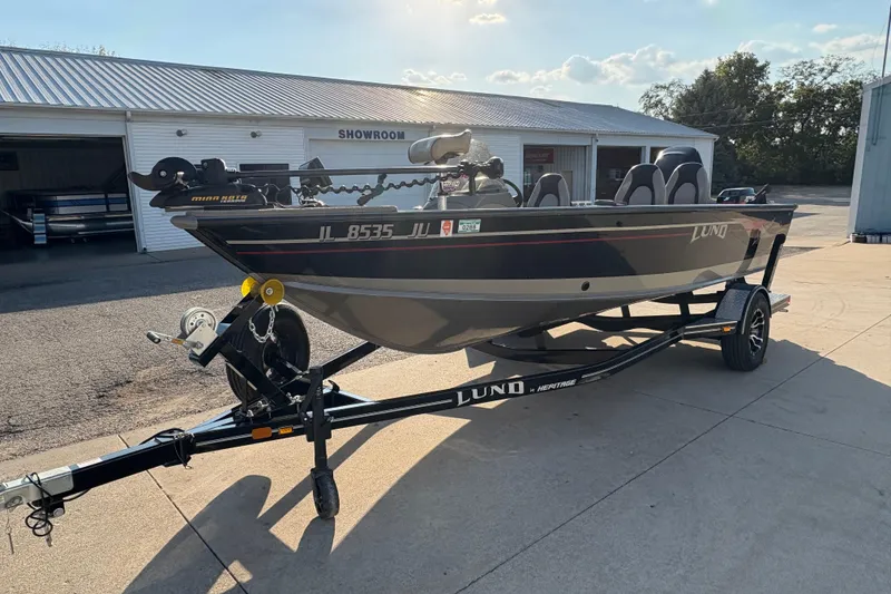 Slide: The Image of 2004 Lund 1800 Explorer SS fishing boat on trailer outside showroom. - 5