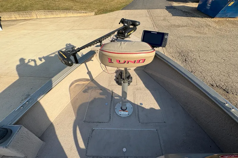 Slide: The Image of 2004 Lund 1800 Explorer SS boat interior with seat and fishing equipment. - 9