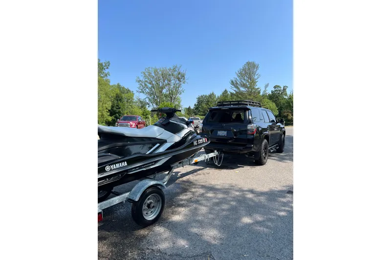 Slide: The Image of 2017 Yamaha WaveRunner EX Sport on trailer, parked with SUV in sunny outdoor setting. - 8