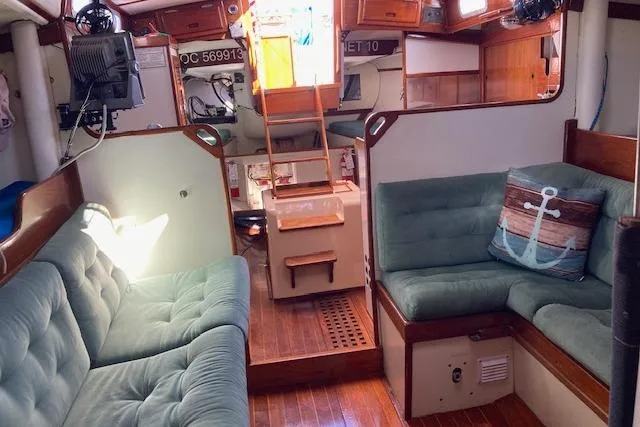 Slide: The Image of Interior of a 1975 Tartan 41 sailboat with cozy seating and nautical decor. - 12