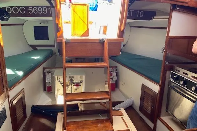 Slide: The Image of Interior of a 1975 Tartan 41 sailboat with wooden ladder and cozy berths. - 14