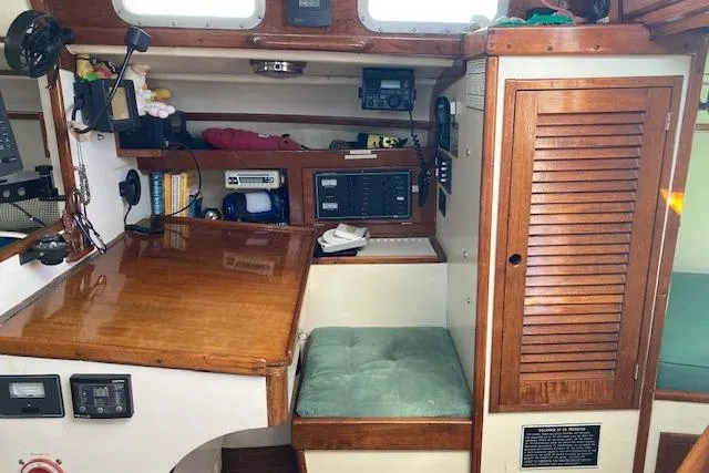 Slide: The Image of 1975 Tartan 41 yacht interior with wooden cabinetry and navigation equipment. - 18