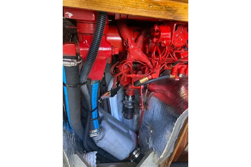 Slide: The Image of Engine compartment of a 1975 Tartan 41 sailboat with red components and hoses. - 23