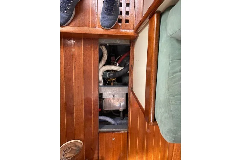 Slide: The Image of Interior view of 1975 Tartan 41 sailboat showing wooden flooring and engine compartment. - 25