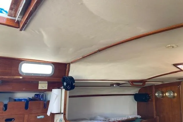 Slide: The Image of Interior of 1975 Tartan 41 sailboat with wooden cabinetry and porthole window. - 29