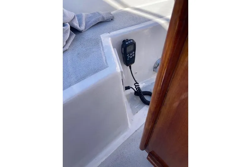 Slide: The Image of 1975 Tartan 41 sailboat cockpit with mounted radio and wooden trim. - 32