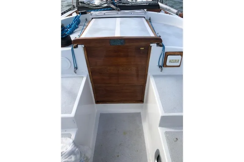 Slide: The Image of 1975 Tartan 41 sailboat cockpit with wooden hatch and white seating. - 33