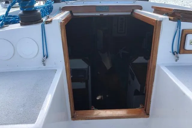 Slide: The Image of 1975 Tartan 41 sailboat cabin entrance with blue ropes and wooden trim. - 35